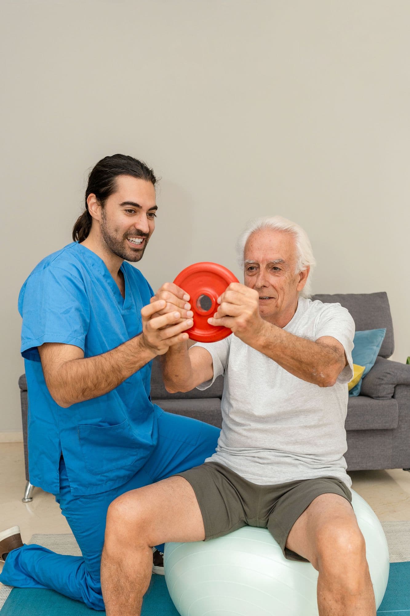 Physiotherapist guiding a patient through dumbbell exercises